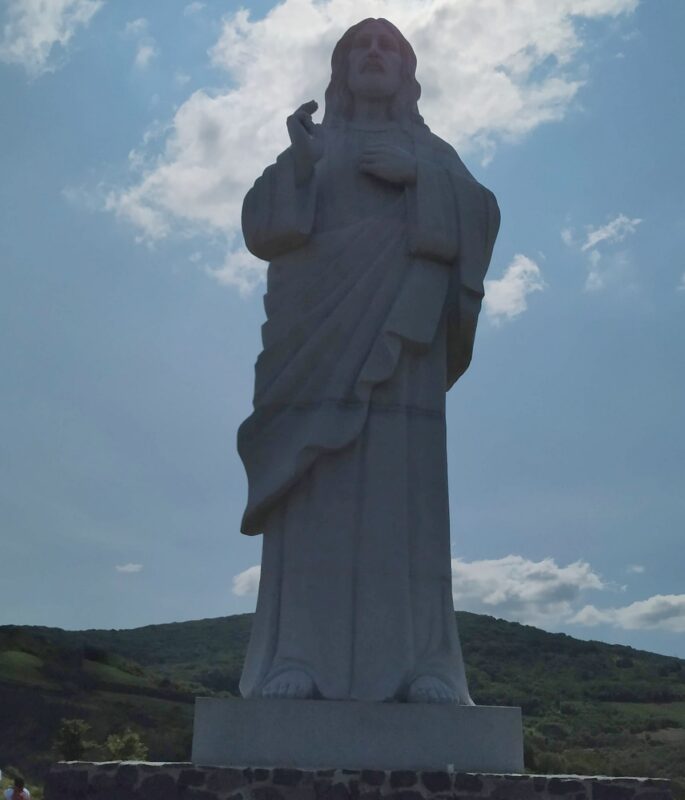 The Jesus statue in Tarcal seen standing in front of it