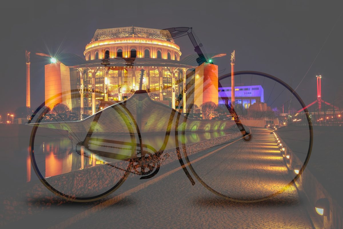 How do you travel by bike to the Athletics Stadium from Buda (across the Rákoczi Bridge)?